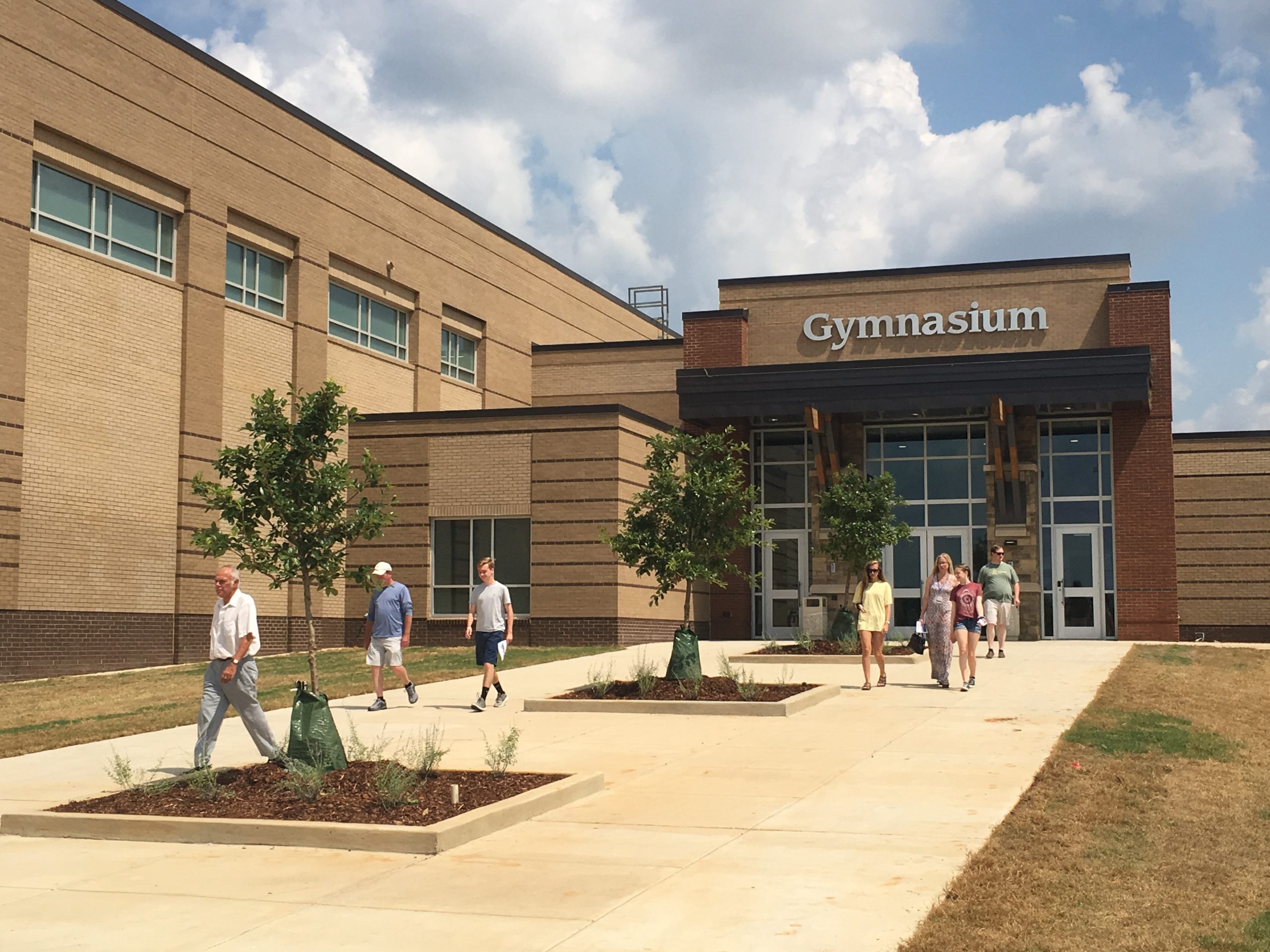 entrance to the gymnasium at grissom high school with people exiting