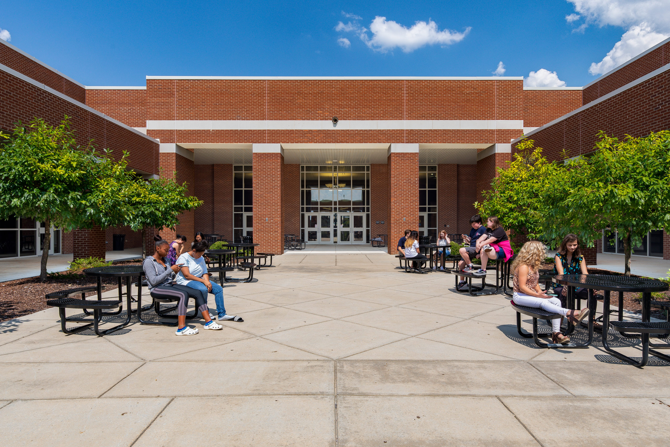patio area at james clemson high school with picnic tables